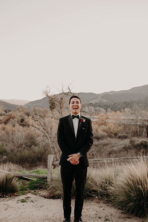 Highway-West-Vacations-groom-alone-in-a-black-tuxedo-with-a-velvet-bow-tie