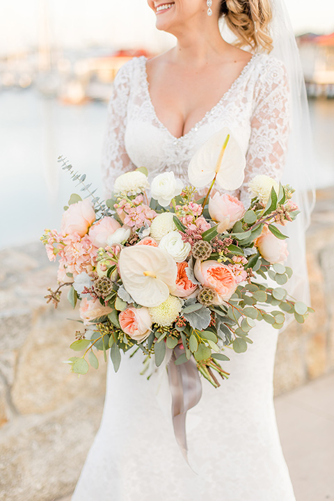 Bride holds colorful bouquet of flowers at the Hotel Del Coronado