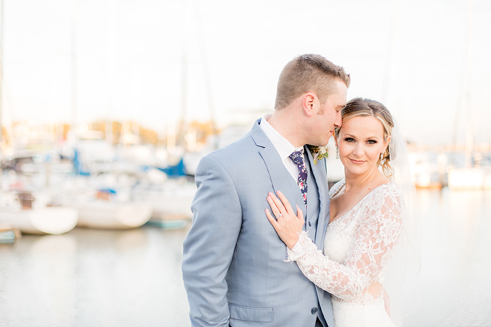 Groom looks at bride while bride looks at camera