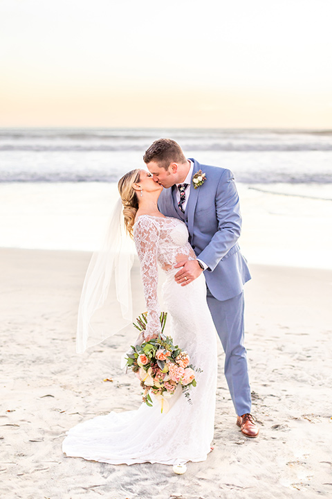 Bride and groom kiss on the beach in Coronado