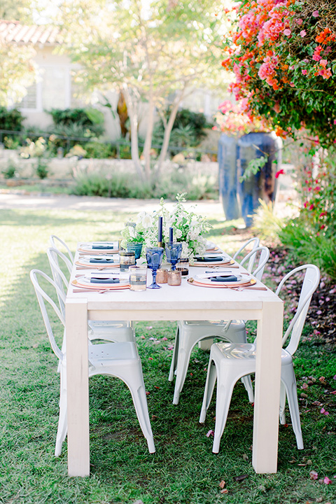  white table and chairs with blush and navy decor 