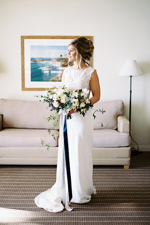 The-Inn-at-Laguna-Beach-bride-standing-bride-in-a-form-fitting-gown-with-a-high-slit-and-high-neckline