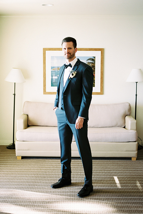 The-Inn-at-Laguna-Beach-groom-standing-groom-in-a-slate-blue-suit-with-a-matching-bow-tie