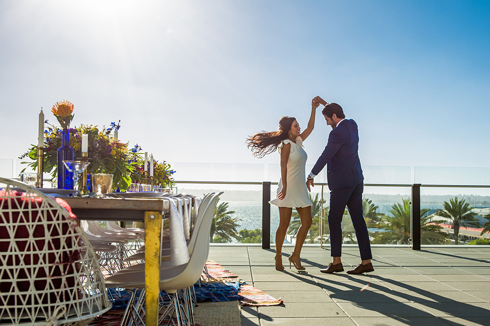 Intercontinental-elopement-shoot-bride-and-groom-dancing-groom-in-a-cobalt-blue-suit-with-a-floral-tie-bride-in-a-flowing-gown-with-straps-and-lace