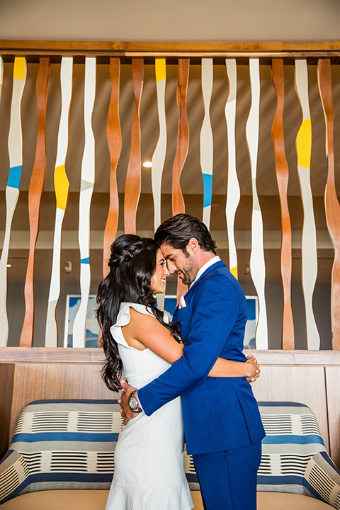 Intercontinental-elopement-shoot-bride-and-groom-touching-heads-bride-in-a-short-dress-with-straps-groom-in-a-royal-blue-suit