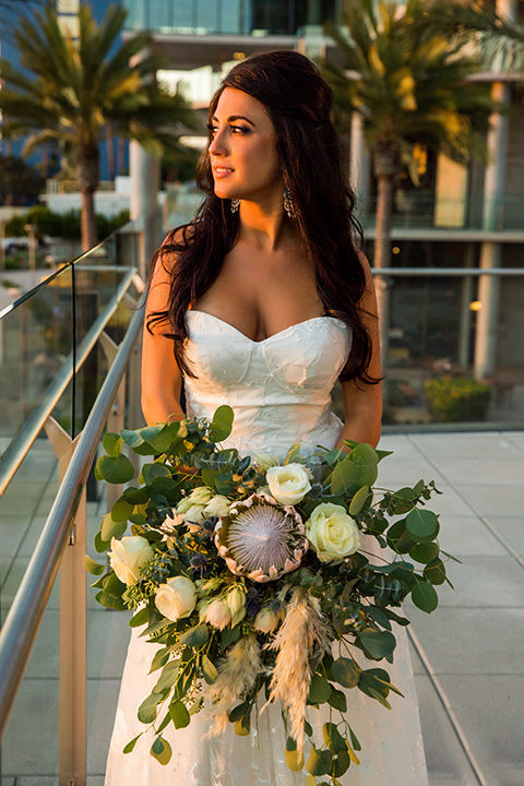 Intercontinental-elopement-shoot-bride-looking-out-on-the-patio-in-a-flowing-lace-gown-with-straps