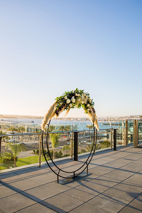 Intercontinental-elopement-shoot-ceremony-arch-in-a-circle-design-with-flowers