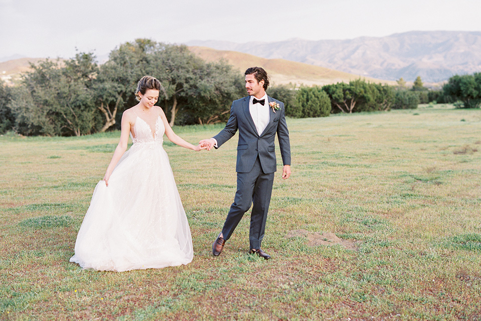 italian-style-wedding-bride-and-groom-walking-in-meadow