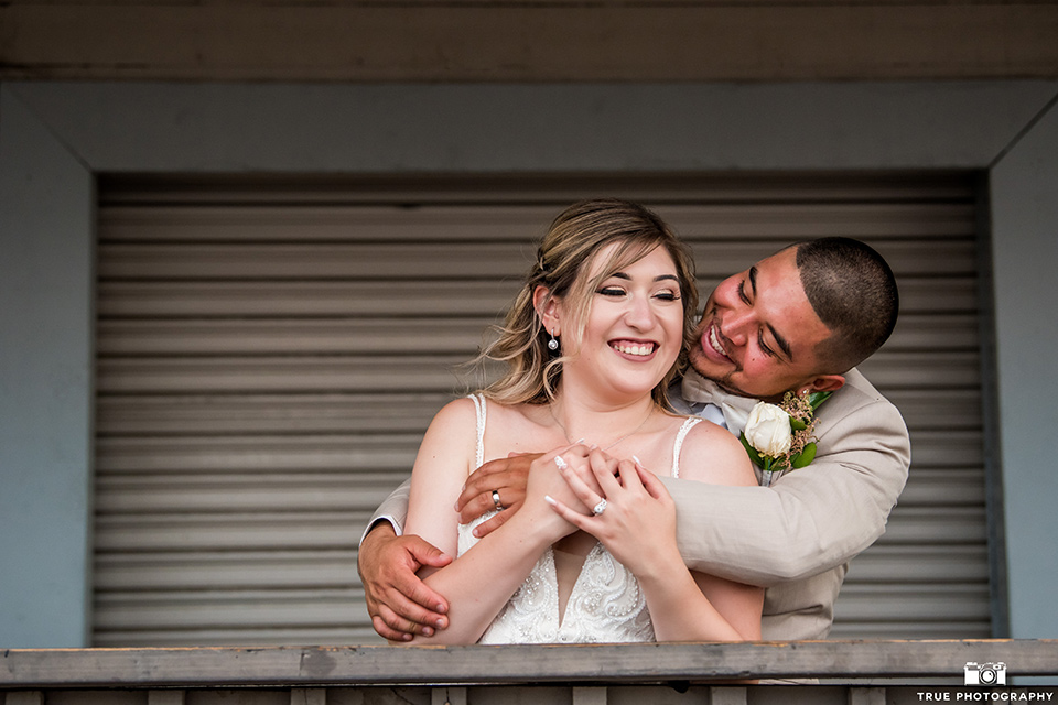 San Diego wedding groom holding the bride from behind 