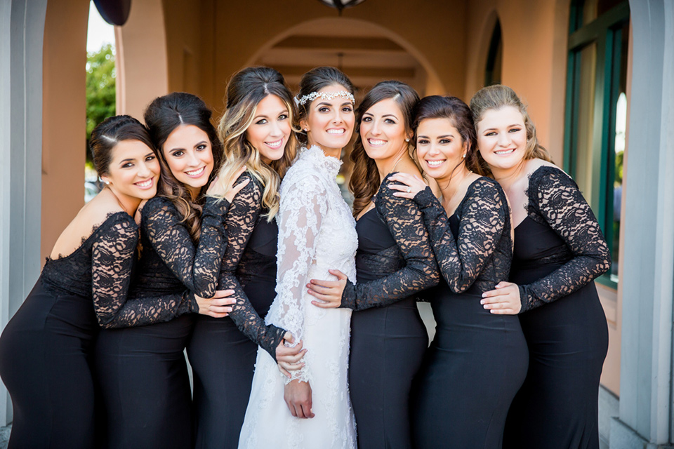  bridesmaids in black lace gowns bride in a lace and tulle gown with a high neckline and sleeves