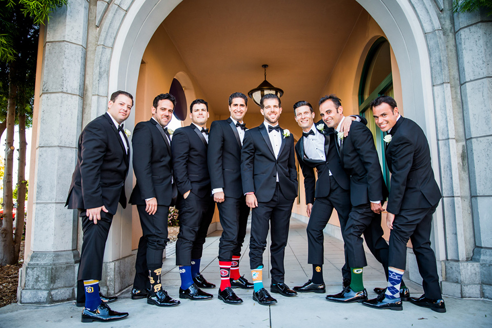 Admiral Kidd Club groomsmen and socks groomsmen in black tuxedos groom in a traditional black tuxedo