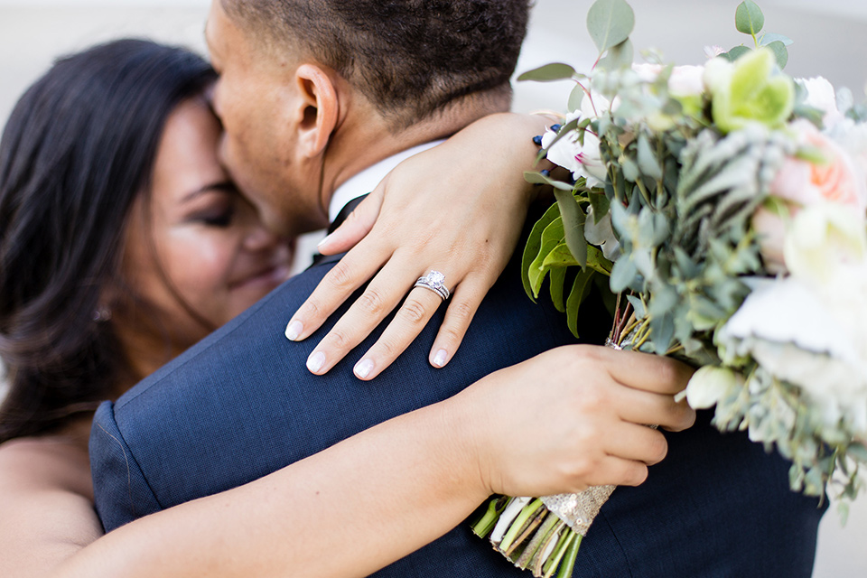 walt-disney-concert-hall-bride-and-groom-hugging-bride-in-a-strapless-white-gown-with-a-sweetheart-neckline-groom-in-a-navy-tuxedo