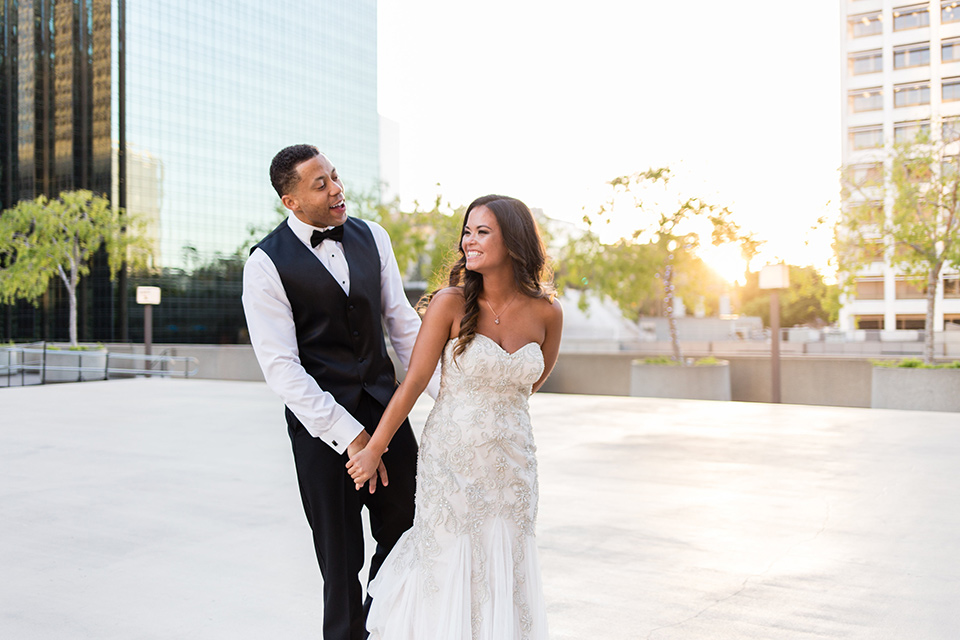 walt-disney-concert-hall-bride-and-groom-laughing-bride-in-a-strapless-white-gown-with-a-sweetheart-neckline-groom-in-a-navy-tuxedo