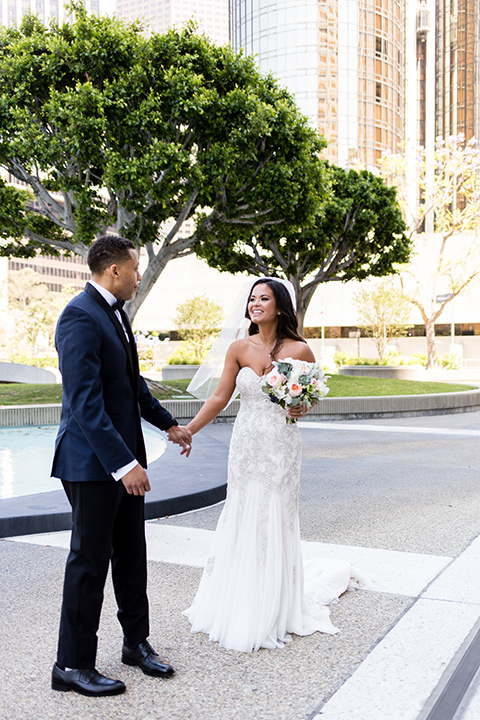 walt-disney-concert-hall-first-look-part-2-groom-in-a-navy-shawl-lapel-tuxedo-with-a-black-bow-tie-bride-in-a-white-strapless-gown-with-a-sweetheart-neckline