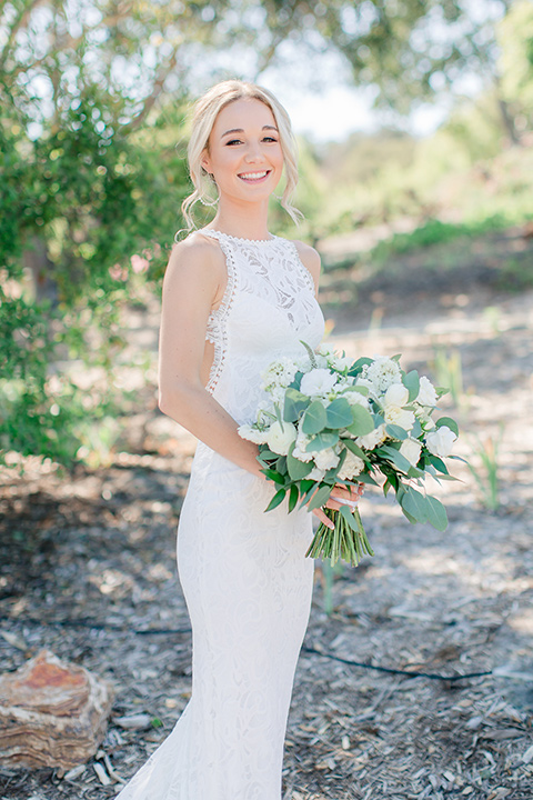 Arroyo-Grande-Wedding-bride-with-flowers-in-a-bohemian-style-gown-with-a-high-neckline-anda-open-back