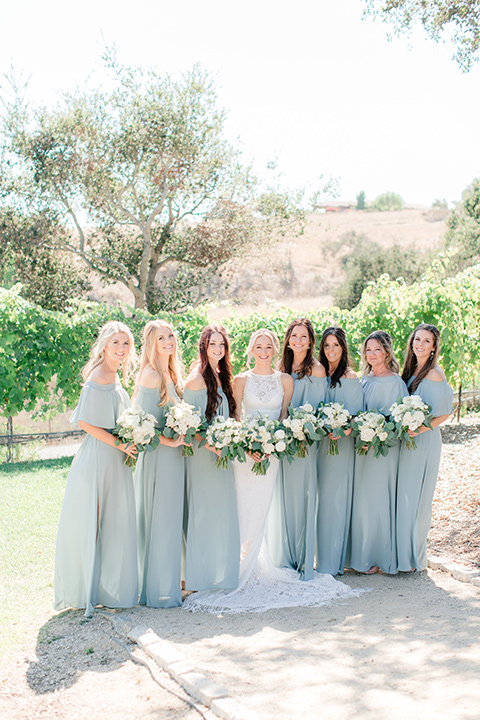 Arroyo-Grande-Wedding-bridesmaids-bride-in-a-boho-style-gown-with-a-keyhole-back-and-high-neckline-and-fringe-the-bridesmaids-wore-light-sage-off-the-shoulder-dresses