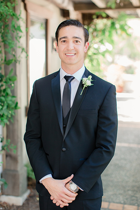 Arroyo-Grande-Wedding-groom-close-up-wearing-a-black-tuxedo-and-black-long-tie