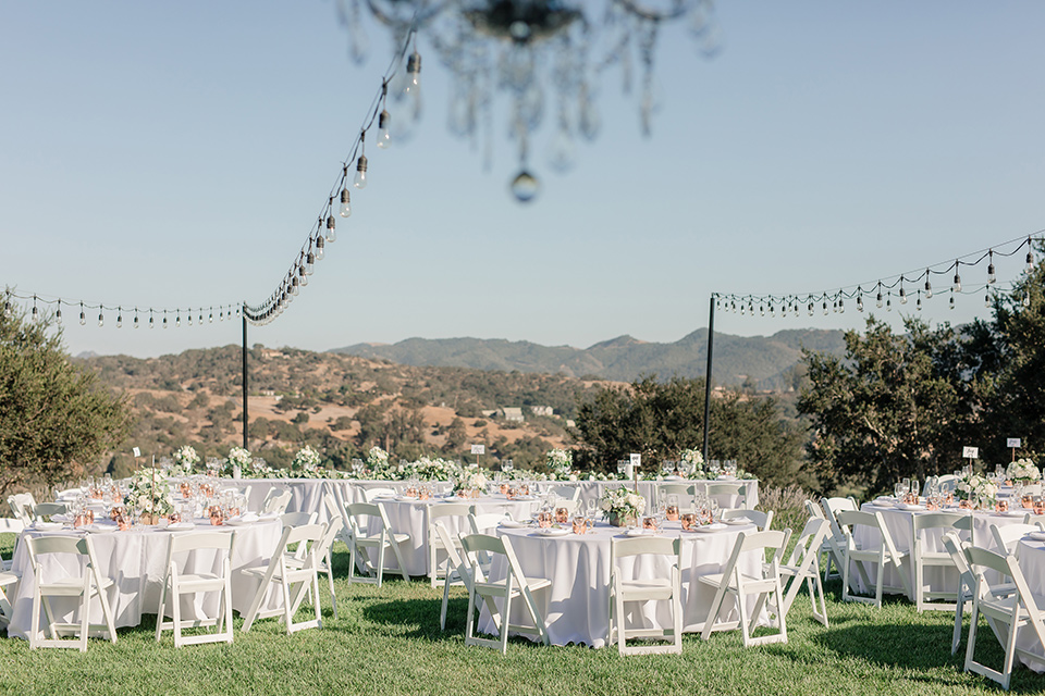 Arroyo-Grande-Wedding-reception-space-with-white-tables-and-chairs-with-string-lights-overhead
