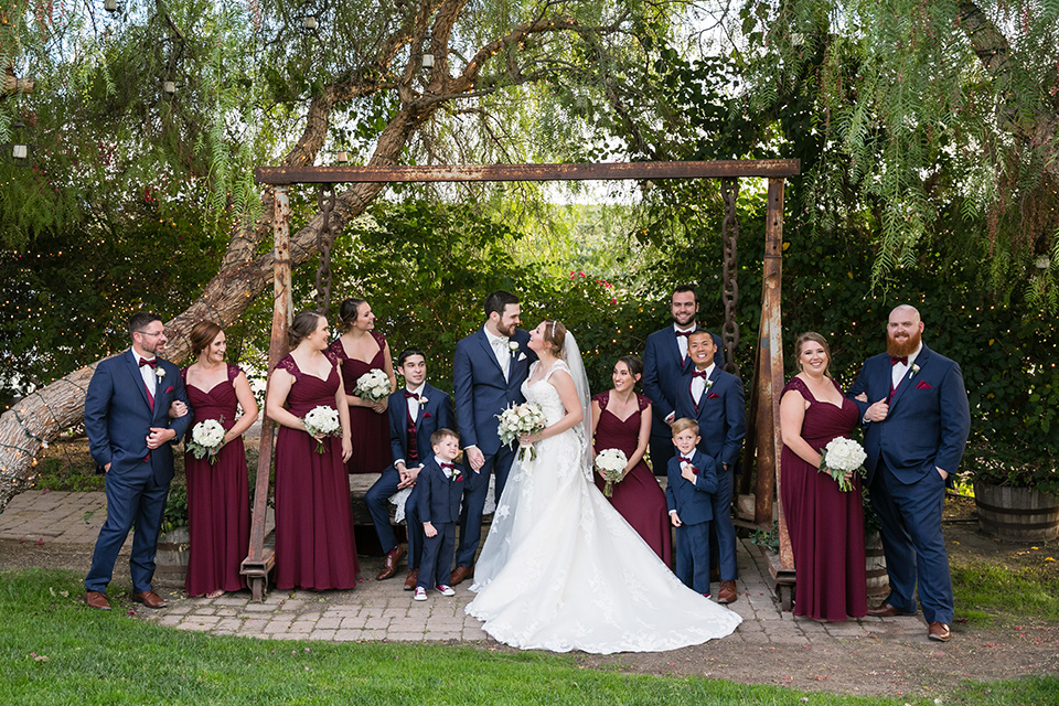 entire birdal party poses in front of lush green trees at Villa de Amore Wedding venue