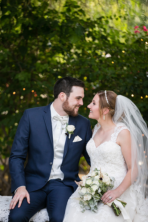 Villa de amore wedding bride and groom with the bride wearing a white ballgown with a tulle skirt and the groom wearing a blue suit