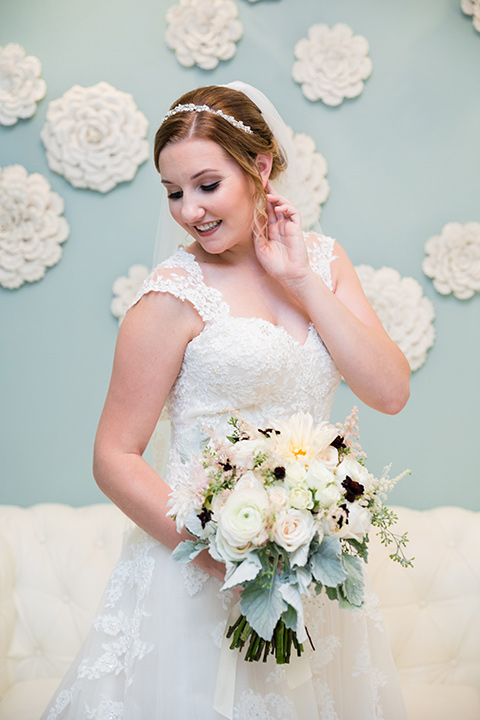 Villa de Amore wedding bride looking over her shoulder with bride wearing a white ballgown with a tulle skirt and lace detailing and thin straps