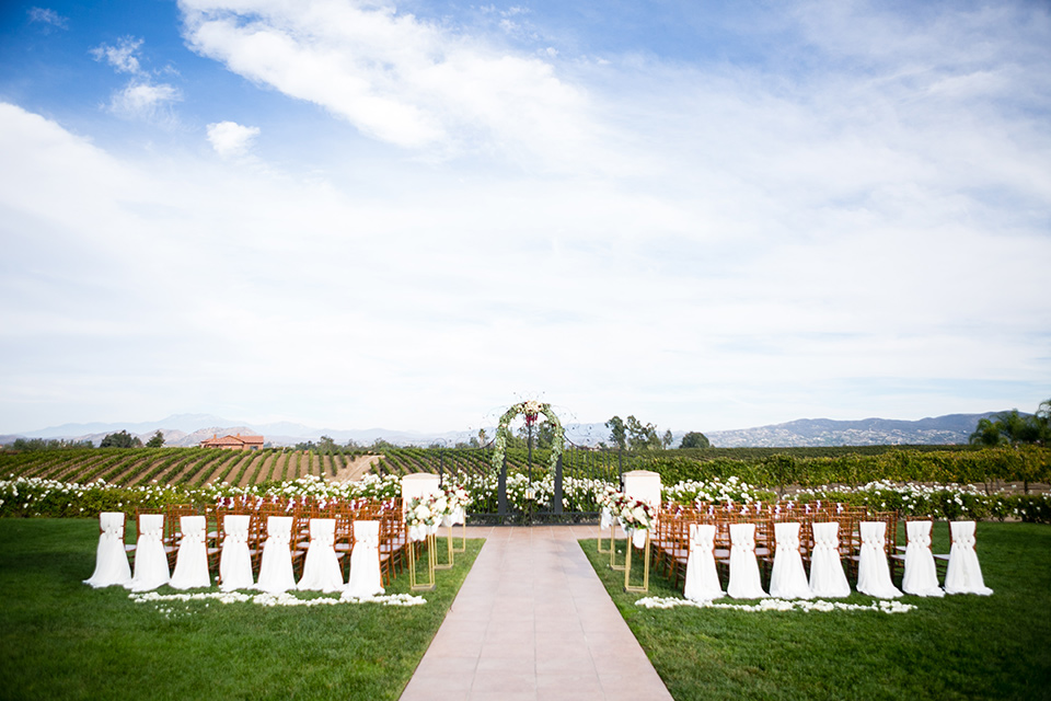 Villa de Amore wedding ceremony space with white chairs and flowing white linens