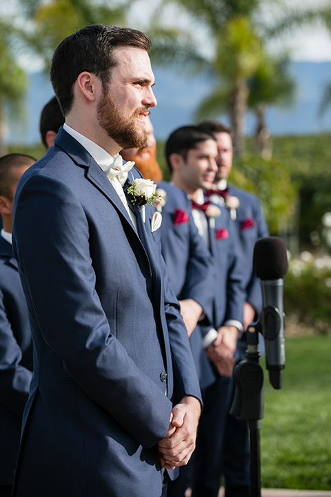 Villa de Amore wedding groom at the ceremony wearing a blue suit and a white bow tie