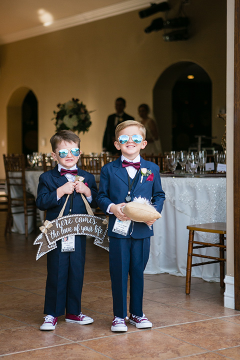 ring bearers wearing little dark blue suits and wearing sunglasses 