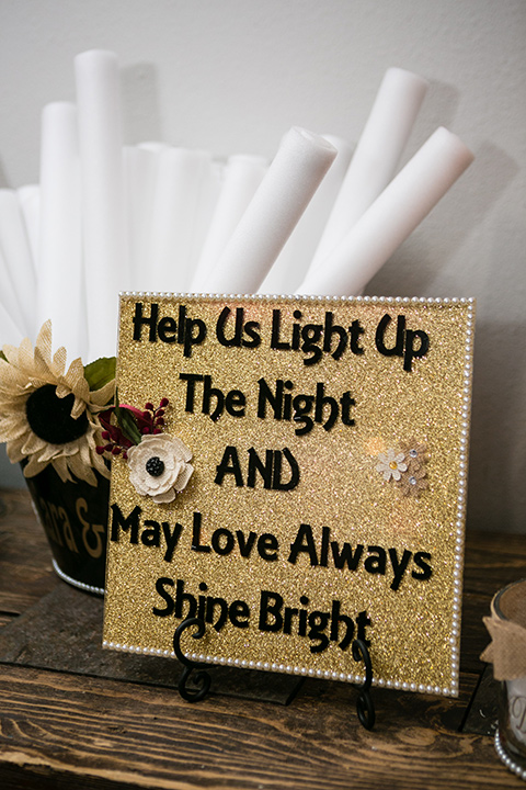 wedding signage on gold background with black bold lettering 