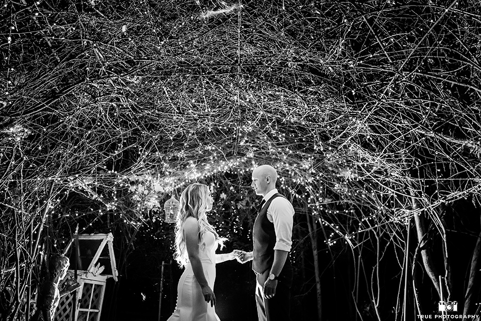 twin-oaks-weddings-bride-and-groom-looking-at-each-other-bride-in-a-strapless-fit-and-flare-gown-with-a-sweetheart-neckline-groom-in-a-charcoal-grey-suit-with-black-long-tie