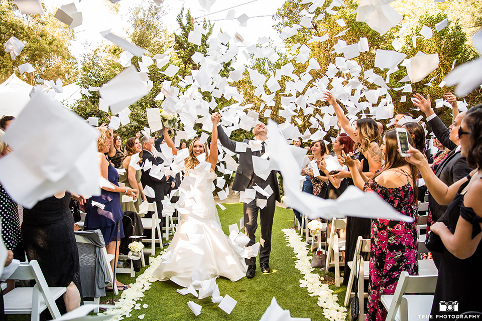 twin-oaks-weddings-bride-and-groom-walk-down-the-aisle-bride-in-a-strapless-fit-and-flare-gown-with-a-sweetheart-neckline-groom-in-a-charcoal-grey-suit-with-black-long-tie