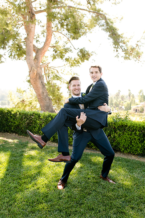 callaway-winery-wedding-groomsman-carrying-groom-in-navy-blue-suits