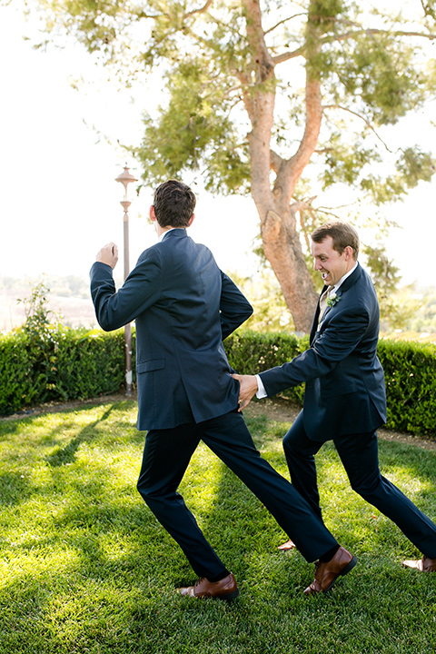 callaway-winery-wedding-groomsmen-running-in-navy-blue-suits