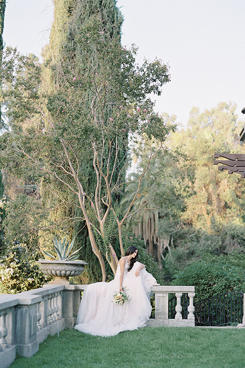 Kimberly-crest-house-shoot-bride-sitting-in-a-modern-princess-inspired-flowing-white-gown-with-a-full-skirt