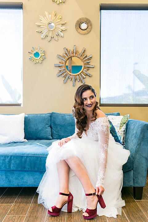  bride in a white lace gown with a full skirt and long lace sleeves and her hair in a finger wave 
