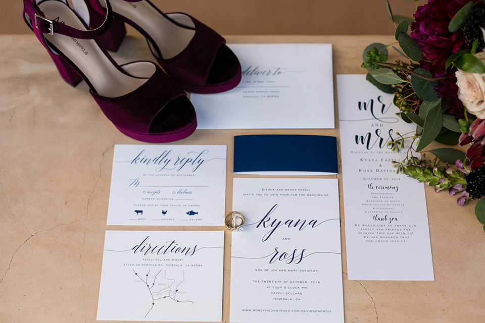  white invitations with burgundy velvet heels and green calligraphy