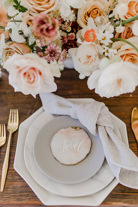 white plates with gold trim and gold flatware