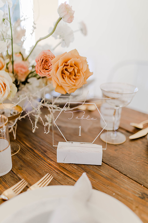 wooden table with white plates and gold deco