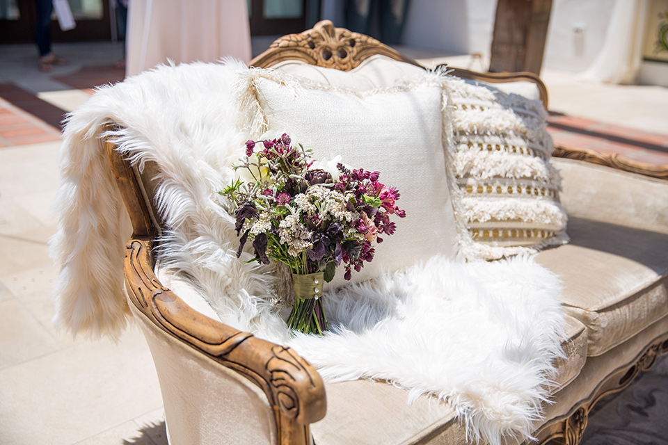 white vintage couch with white fur throw blanket