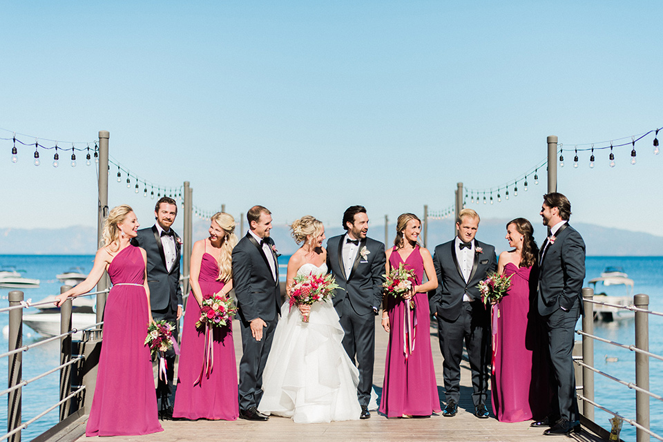 The wedding party poses for photos on a dock in lake tahoe