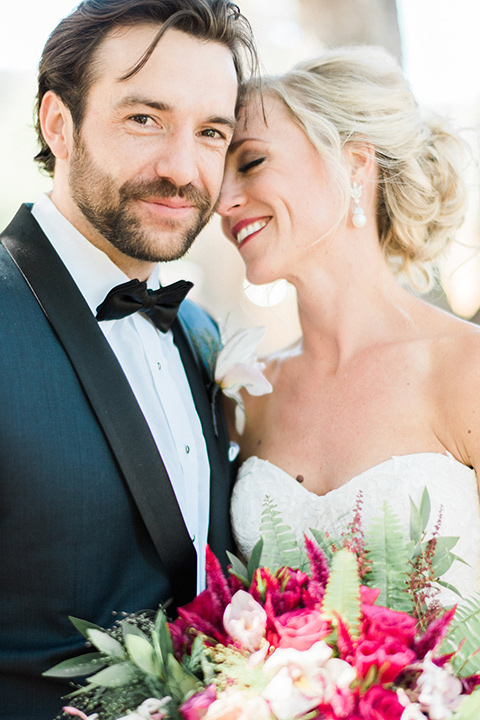 Bride and groom pose for an up-close portrait photo