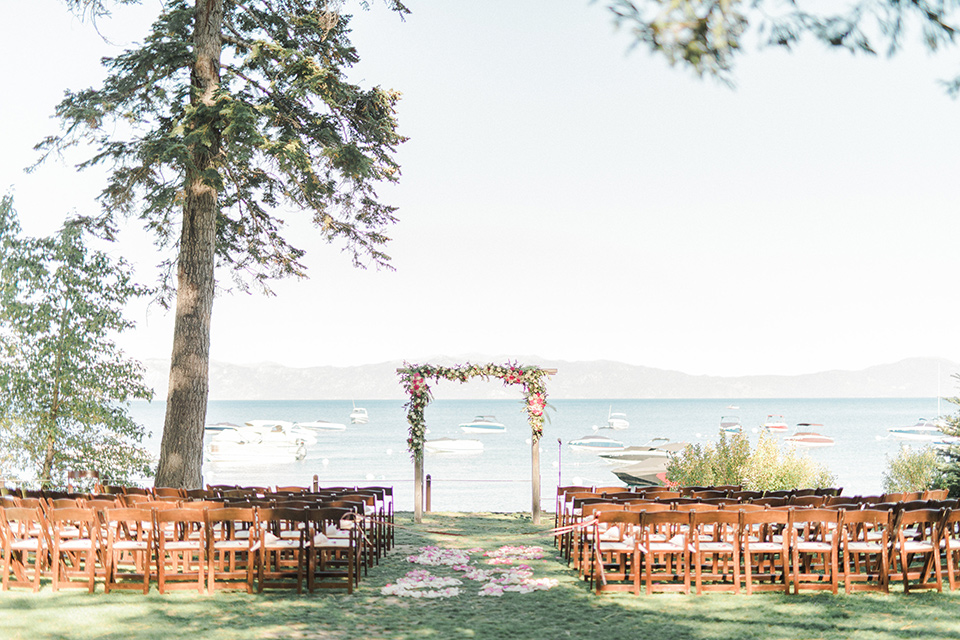 Lake Tahoe wedding ceremony space with wooden chairs and ceremony arch