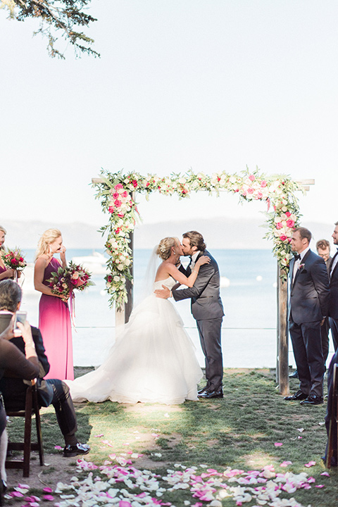 Bride and groom kiss during wedding ceremony