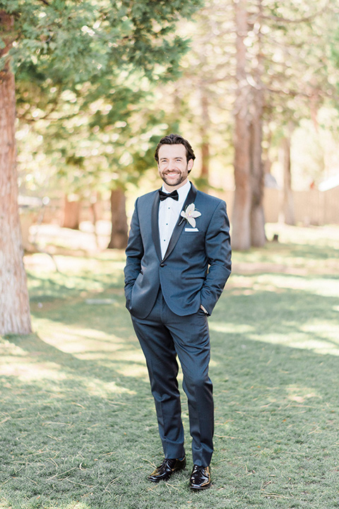 The groom poses for a wedding photo