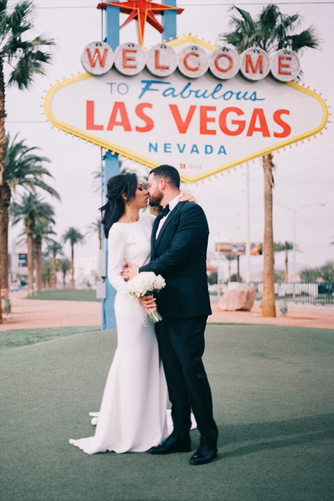 Couple pose for engagement photo in front of Las Vegas sign