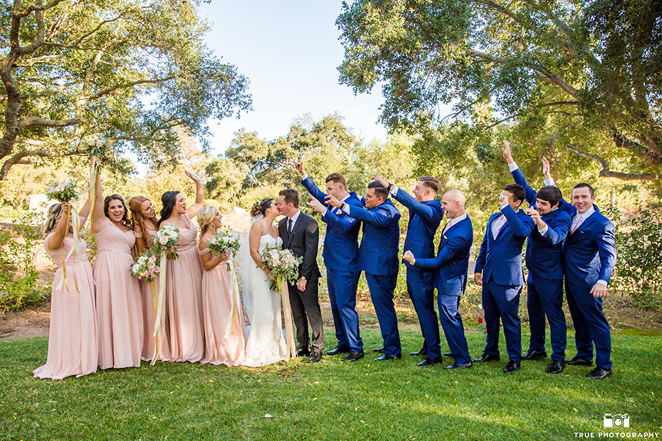 mount-woodson-castle-bridal-party-in-a-line-bridesmaids-in-light-pink-long-dresses-groomsmen-in-cobalt-blue-suits-with-pink-ties-bride-in-a-mermaid-gown-with-lace-detailing-and-a-sweetheart-neckline-groom-in-a-lack-suti-with-a-black-long-tie