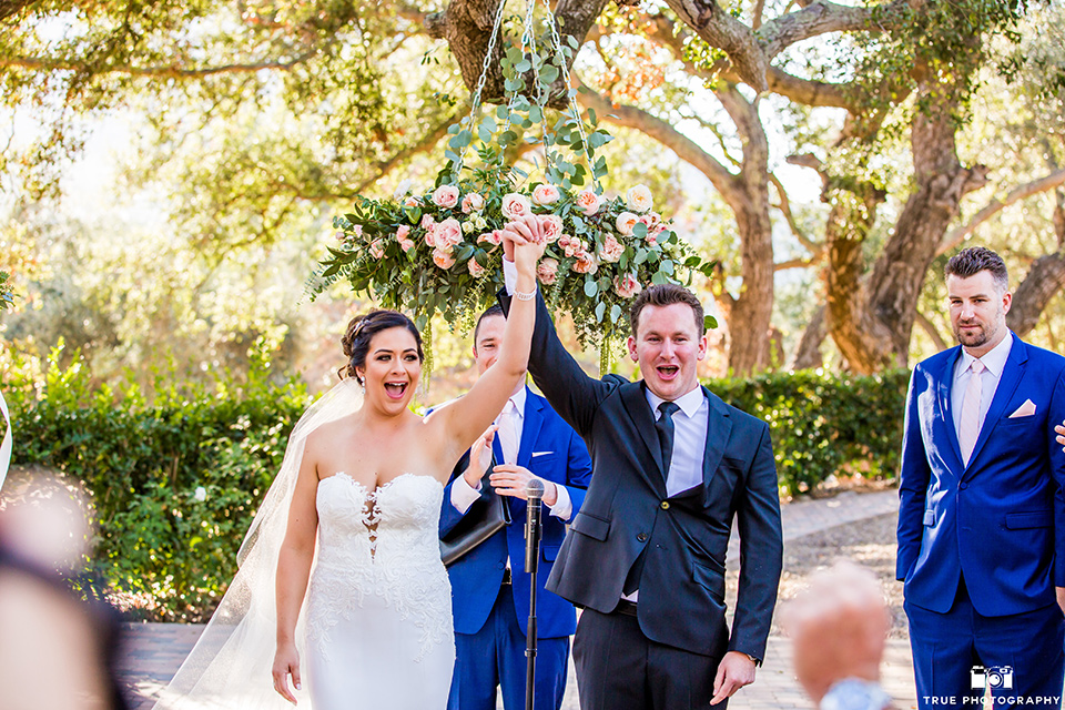 mount-woodson-castle-bride-and-groom-after-ceremony-bride-in-a-mermaid-gown-with-lace-detailing-and-a-sweetheart-neckline-groom-in-a-black-suti-with-a-black-long-tie