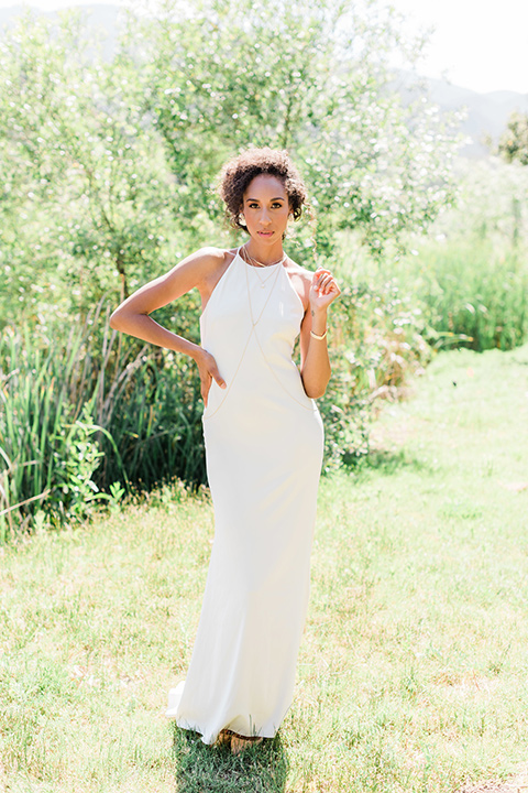 malibu-lodge-spring-wedding-shoot-bride-and-groom-walking-bride-in-a-form-fitting-gown-with-a-high-neckline