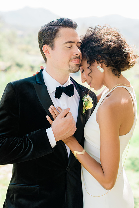 malibu-lodge-spring-wedding-shoot-close-up-of-couple-bride-in-a-high-neckline-dress-groom-in-a-black-velvet-tuxedo