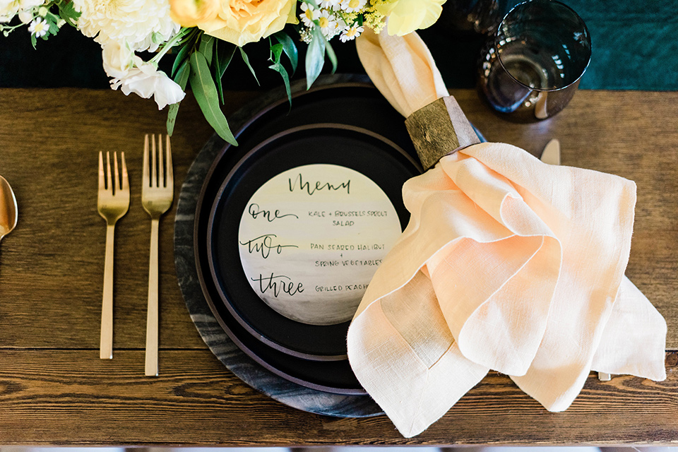 malibu-lodge-spring-wedding-shoot-plates-with-black-plates-and=gold-tableware-and-pink-napkins